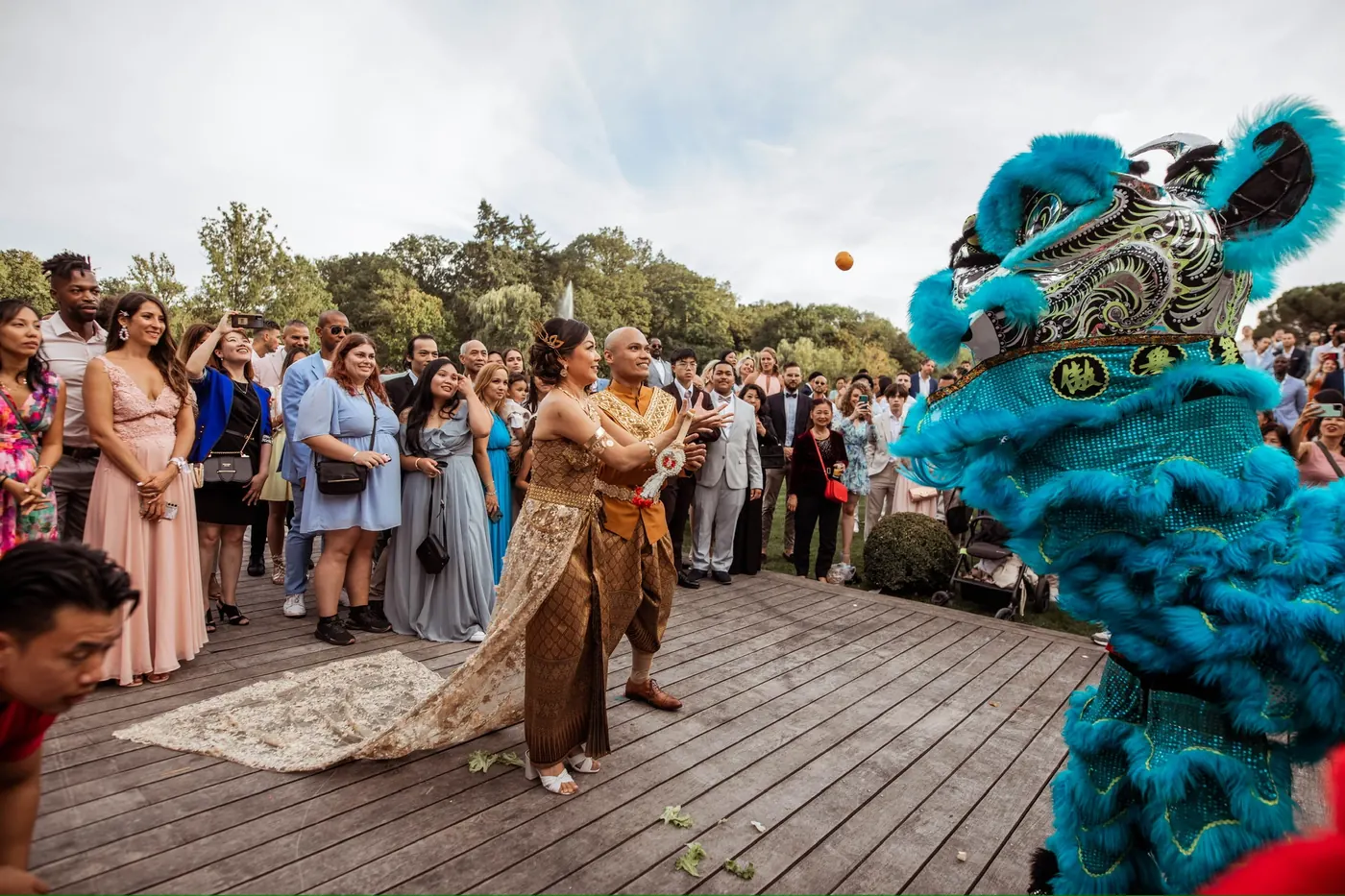 Mariés et lion bleu sous tonnelle — cérémonie en plein air 13AS